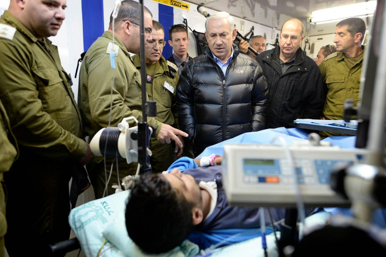 Israeli Prime Minister Benjamin Netanyahu visits at an IDF field hospital, where those wounded in the civil war in Syria were being treated in northern Israel. Feb. 18, 2014. Photo by Kobi Gideon /GPO/Flash90.