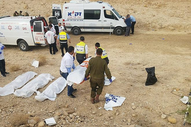 ZAKA emergency volunteers transport the bodies of nine students killed during flash floods while hiking as a group in the Nahal Tzafit riverbed on April 26, 2018. Photo courtesy of ZAKA.