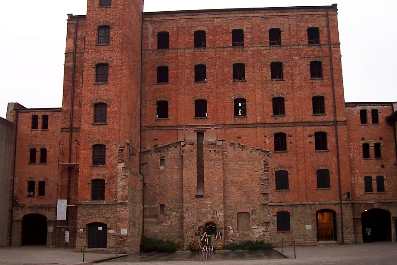 The internal courtyard of Risiera di San Sabbio, the five-story  compound in Trieste, Italy, that functioned during World War II as a Nazi concentration camp for the detention and killing of political prisoners and Jews, most of whom were eventually deported to Auschwitz. The remains of the crematorium used by the Nazis, who destroyed it before escaping, can be seen on the wall. (Wikimedia Commons)