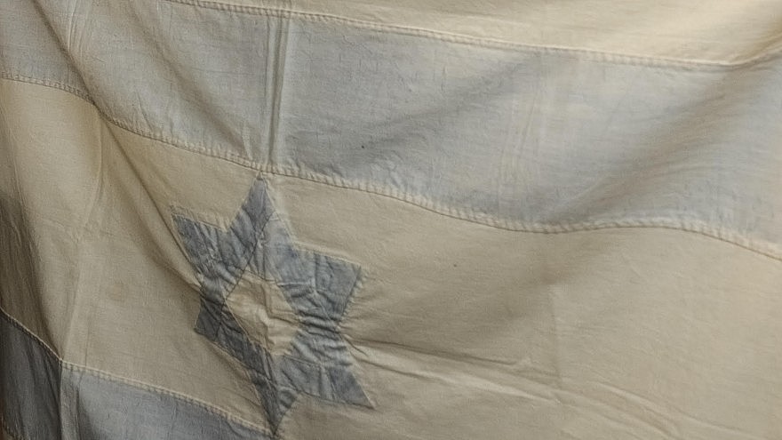 An Israeli flag created by Rebecca Affachiner, often called “the Betsy Ross of Israel,” donated to the Ben-Gurion Archives at the university’s Sde Boker Campus. Credit: American Associates, Ben-Gurion University of the Negev.