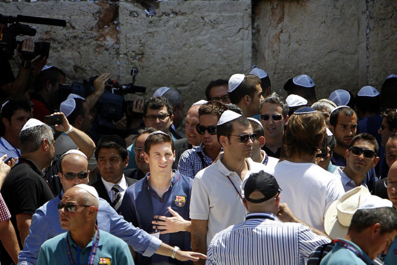 Lionel Messi (center) seen surrounded by press and security, as he and the FC Barcelona team arrive at the Western Wall in Jerusalem on Aug. 4, 2013. Photo by Miriam Alster/Flash90.
