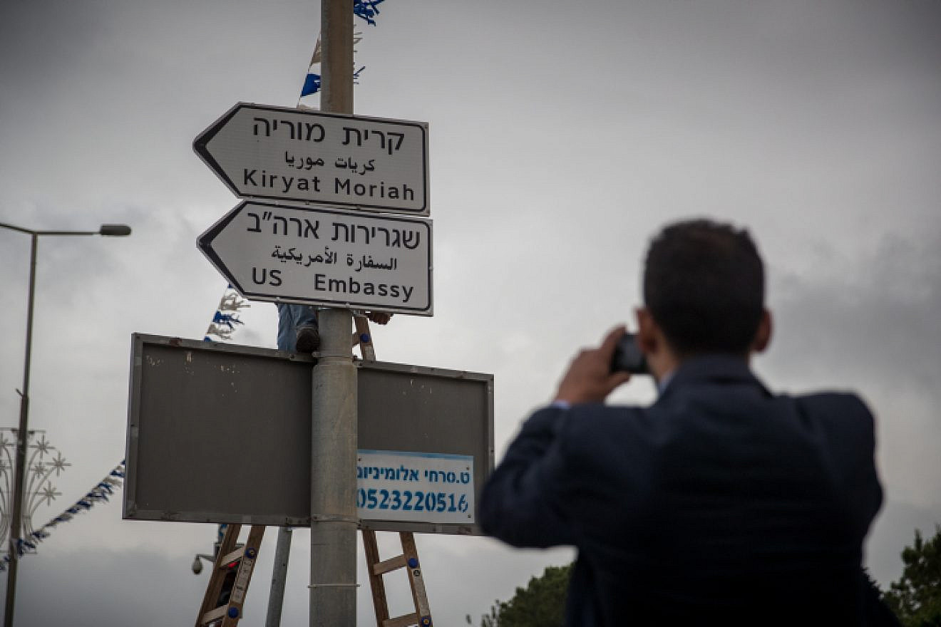 Municipal workers hang a road sign directing to the new U.S. embassy near the U.S. consulate in Jerusalem on May 7, 2018. Photo by Yonatan Sindel/Flash90.