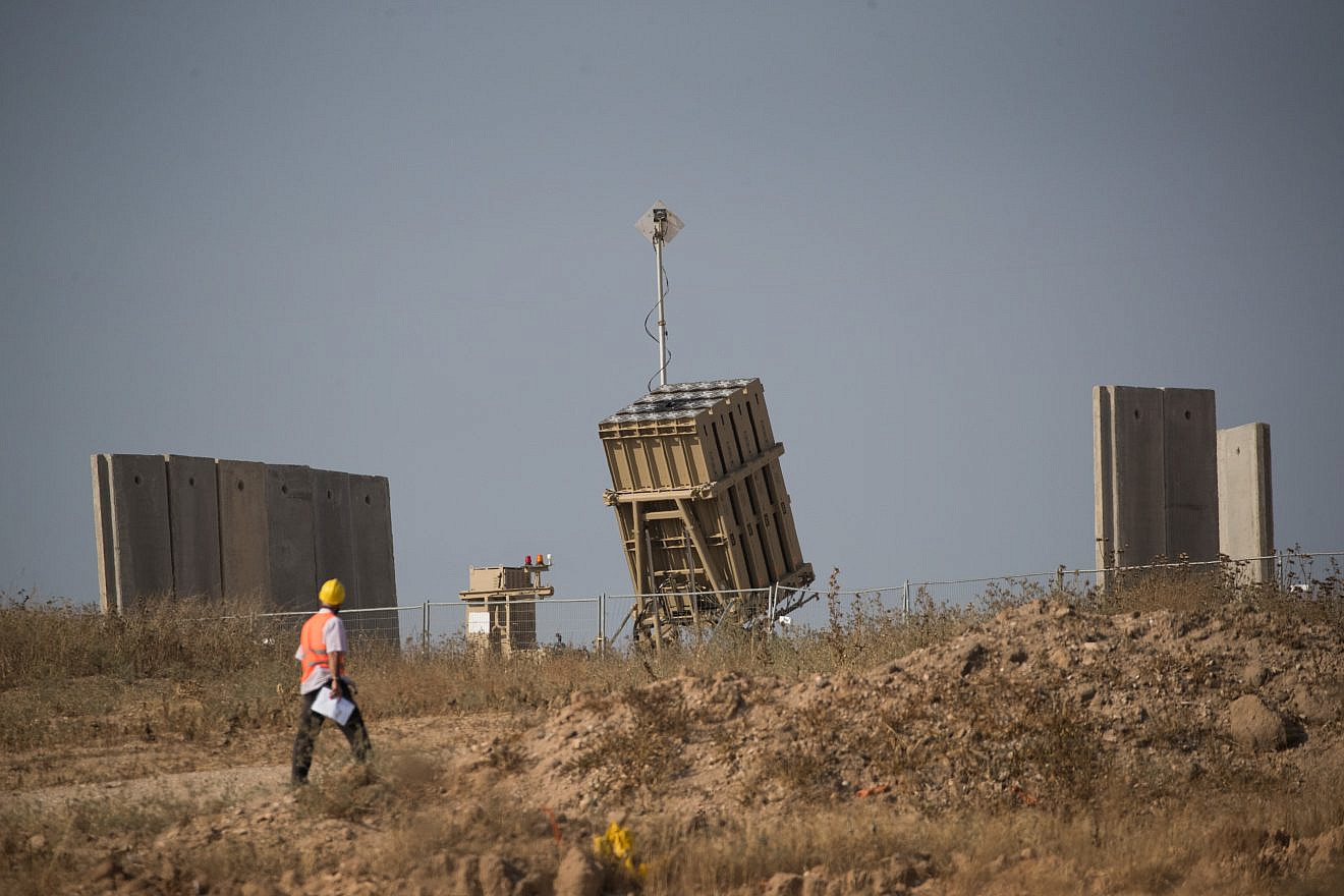A man walks near an Iron Dome missile-defense system near the city of Sderot in southern Israel on May 29, 2018. Photo by Yonatan Sindel/Flash90.