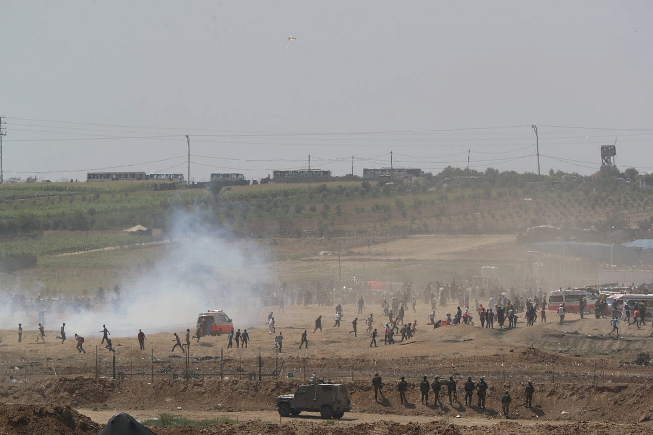 Palestinians burn tires as they protest by the fence on the border between Gaza and Israel, as seen from the Israeli side of the border, June 8, 2018. Photo by Yonatan Sindel/Flash90.