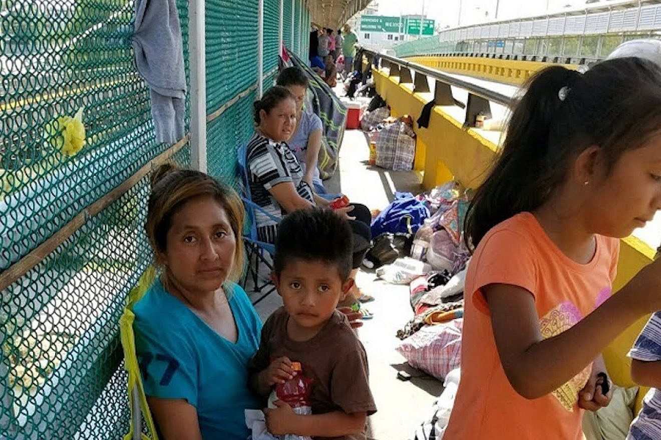 Children with their parents at the U.S.-Mexico border. Source: YouTube.