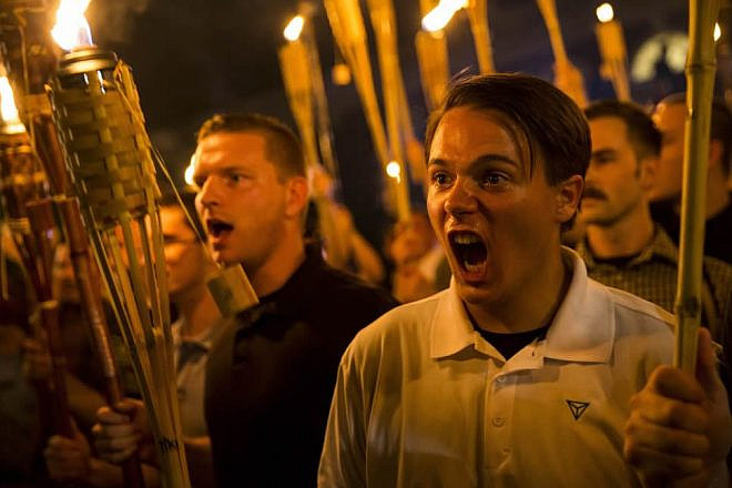 Torch-carrying protesters in Charlottesville march chanting anti-Semitic and anti-minority slogans on Aug. 11, 2017. Source: Twitter.