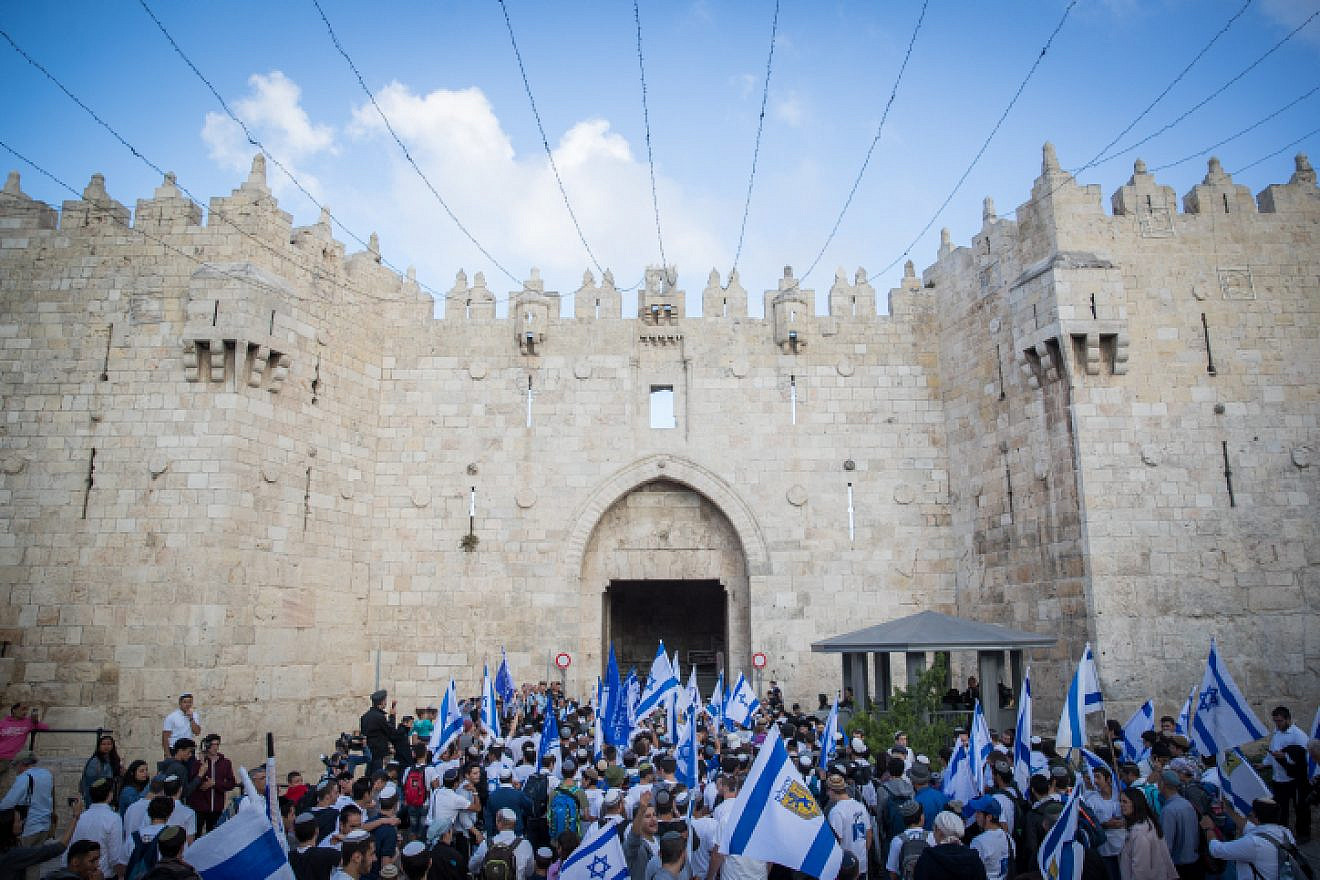 Thousands wave Israeli flags as they celebrate “Jerusalem Day” by dancing through Damascus Gate on their way to the Western Wall. May 13, 2018. Photo by Yonatan Sindel/Flash90.