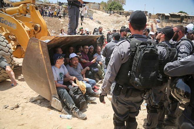Israeli police scuffle with Palestinian demonstrators in the Bedouin village of al-Khan al-Ahmar, east of Jerusalem, on July 4, 2018. Photo by Flash90.