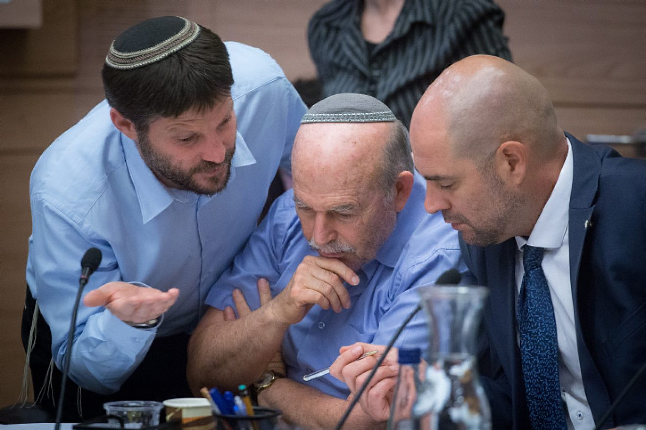 Interim Justice Minister Amir Ohana (right) with Jewish Home parliament members Nissan Slomiansky (center) and Bezalel Smotrich at the joint Knesset and Constitution Committee meeting discussing the proposed National Law at the Knesset, July 16, 2018. Photo by Miriam Alster/Flash90.