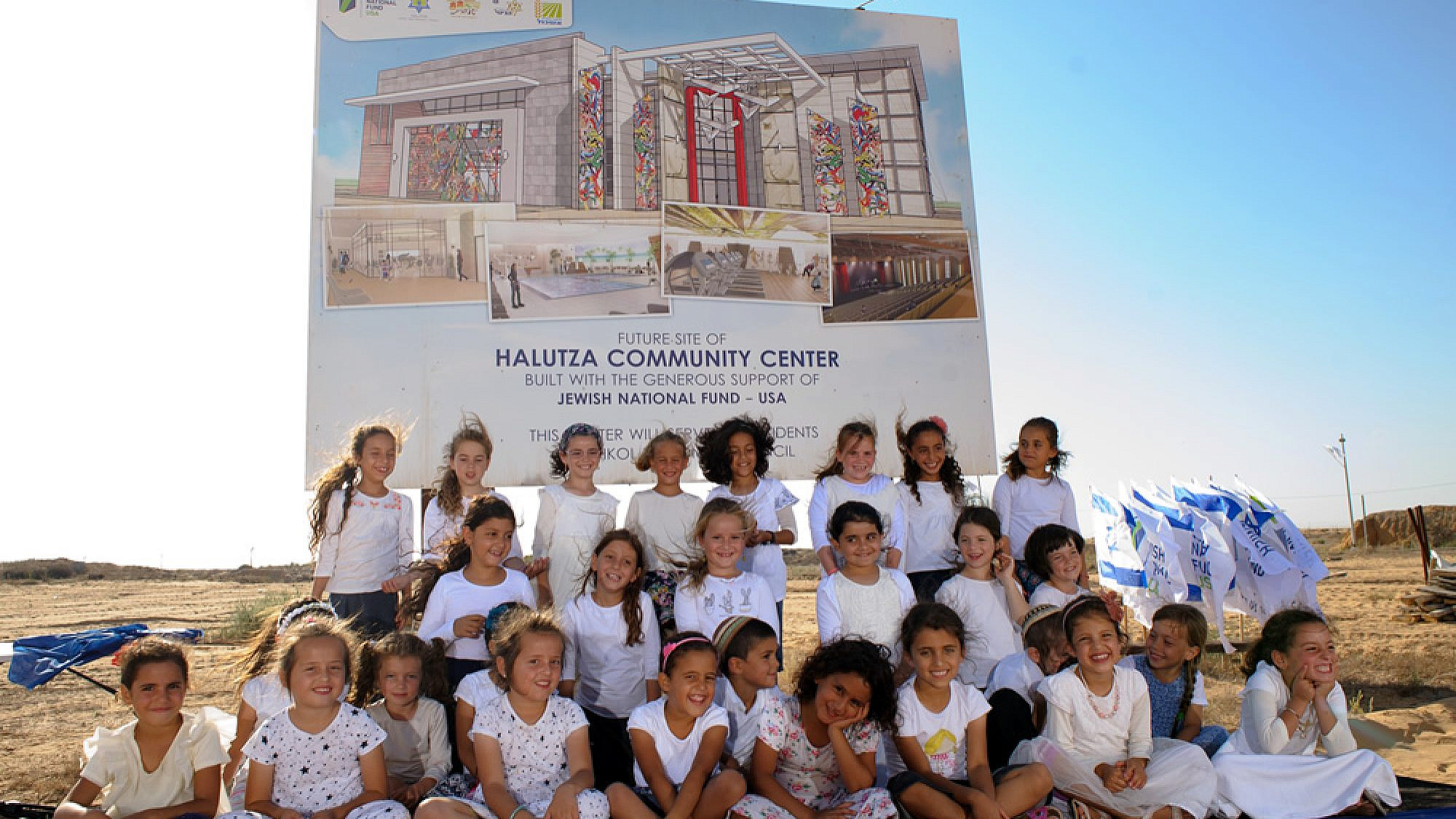 Children of Halutza sit in front of the site of the new state-of-the-art Halutza Community Center. Credit: Jewish National Fund-USA.
