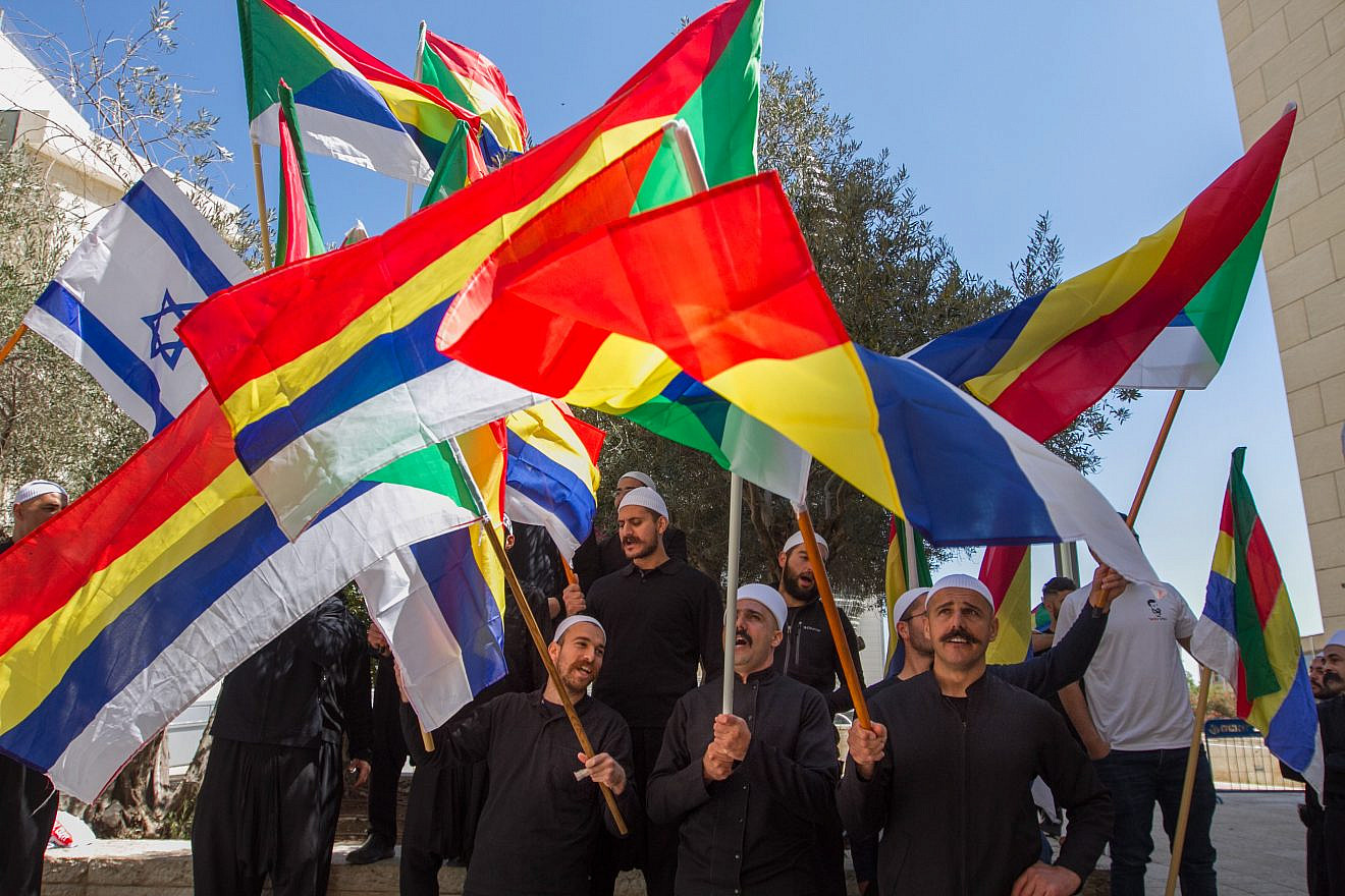 Druze men protest outside the Hafia District Court, carrying both the Druze and the Israeli flags. Photo by Flash90.