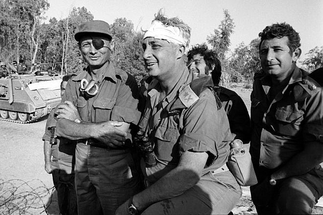 Israeli Defense Minister Moshe Dayan (left) with injured field commander and war strategist Ariel Sharon (center) during the 1973 Yom Kippur War. The Israel Defense Forces Archive Pikiwiki Israel/Wikimedia Commons.