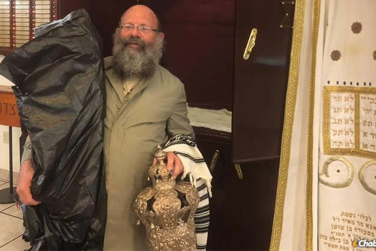 Rabbi Doron Aizenman evacuates Torah scrolls from the Myrtle Beach Chabad synagogue. Credit: Chabad.org/News.