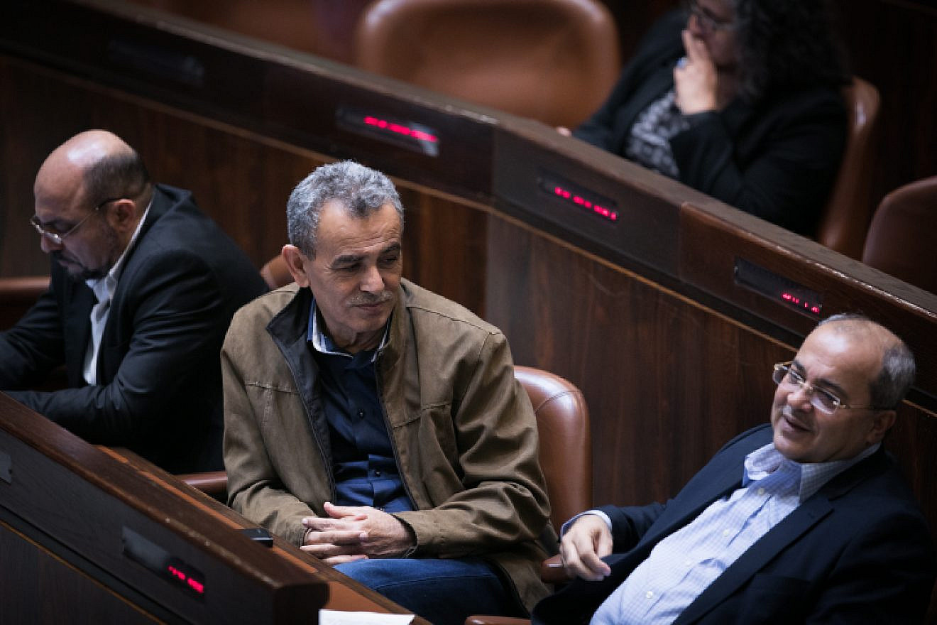Joint Party Knesset members Jamal Zahalka (center) and Ahmad Tibi (right) attend a plenum session in the assembly hall of the Israeli parliament on Dec. 5, 2016. Photo by Yonatan Sindel/Flash90.