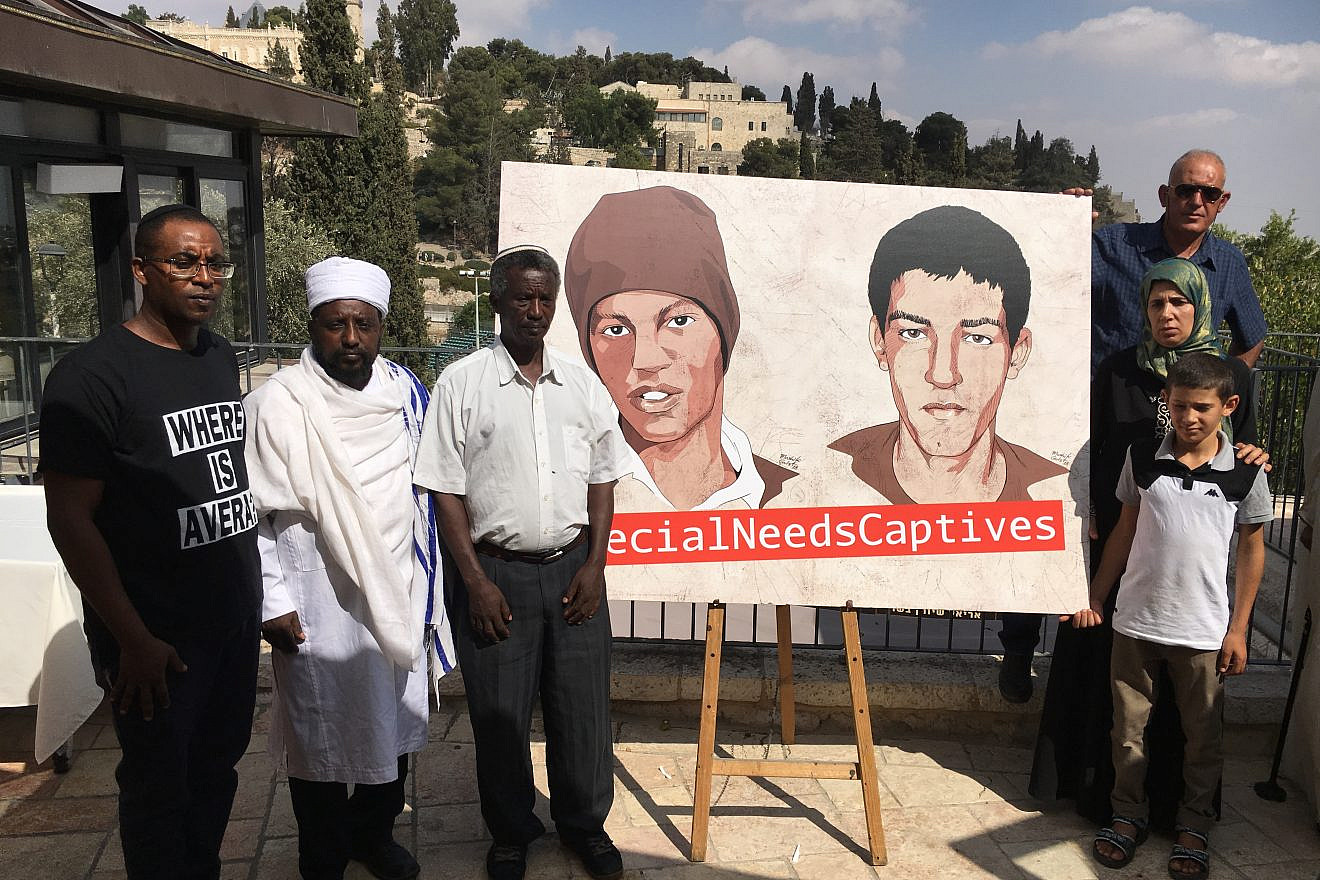 Family members of Avera Mangistu (at left in illustration) call on the United Nations to facilitate his release from the Gaza Strip. Credit: Josh Hasten.