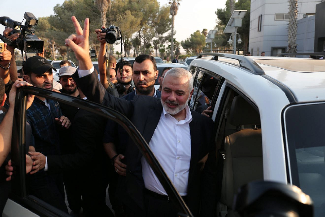 Hamas leader Ismail Haniyeh flashes the victory gesture upon his arrival at the Rafah border crossing from Egypt after reconciliation talks with the Fatah movement mediated by Egyptian intelligence in southern Gaza, Sept. 19, 2017. Photo by Abed Rahim Khatib/Flash90.