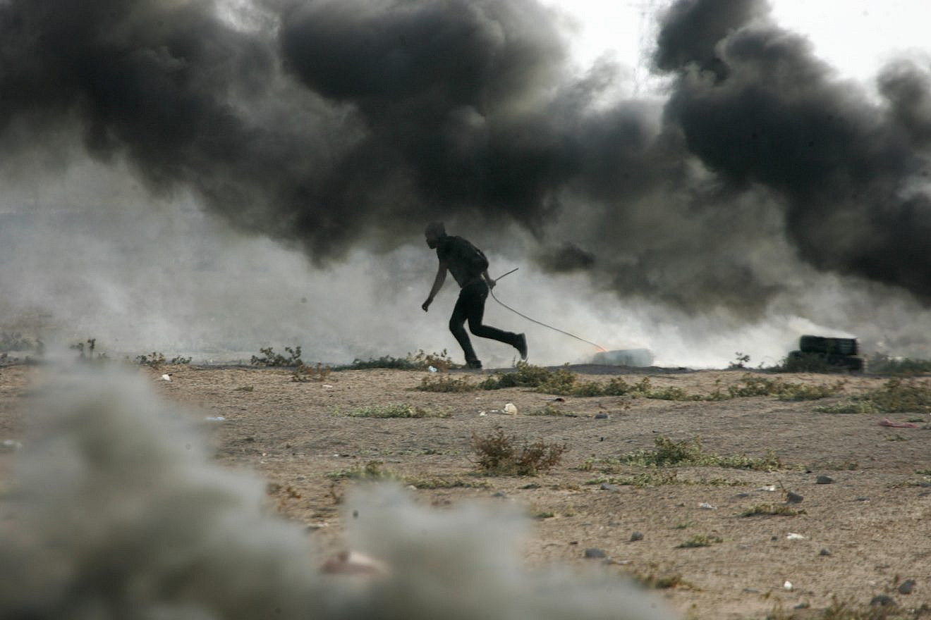 Palestinian demonstrators burn tires as they demonstrate on the Gaza-Israel border on Oct. 12, 2018. Photo by Abed Rahim Khatib/Flash90.