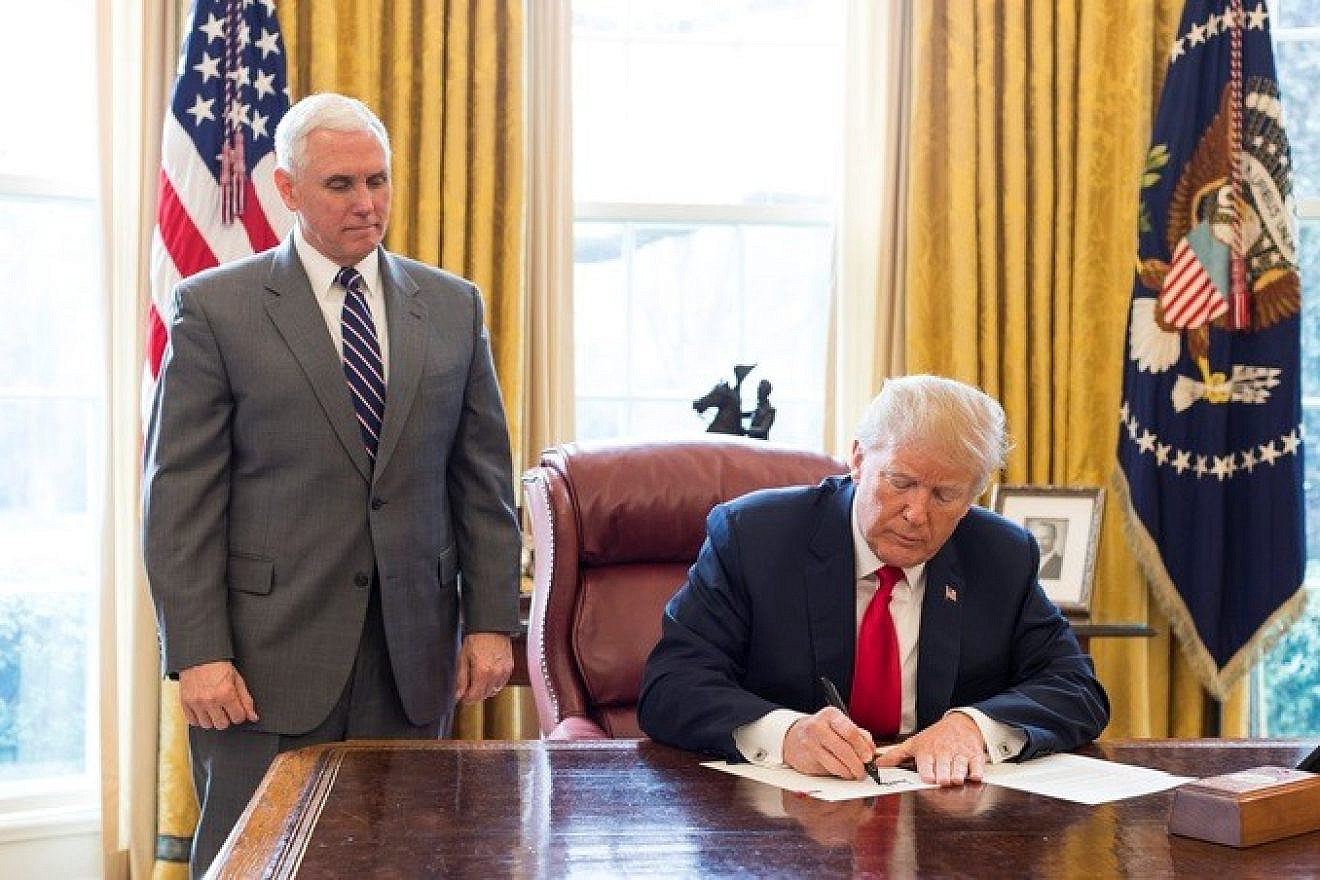 U.S. President Donald Trump, joined by Vice President Mike Pence, signs an executive order on March 19, 2018. Credit: Official White House Photo by Joyce N. Boghosian.