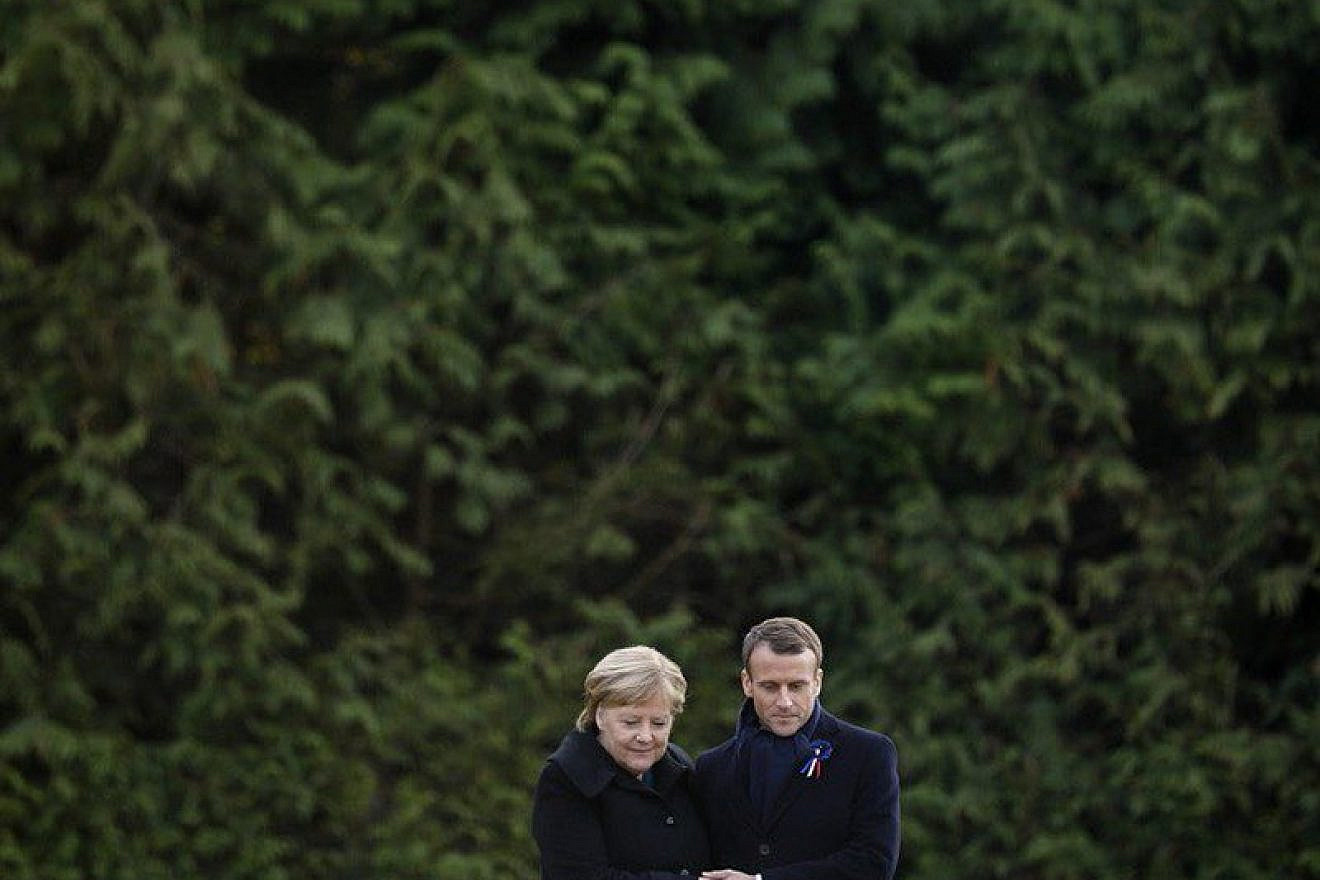 French President Emmanuel Macron and German Chancellor Angela Merkel embrace at a ceremony commemorating the centennial of the end of World War I. Credit: Emmanuel Macron via Twitter.