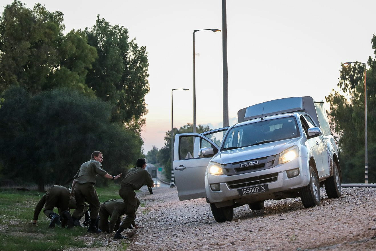 Israeli soldiers lying on the side of the road in southern Israel as they take cover when a siren warns of incoming rockets fired from Gaza into Israel, on Nov. 12, 2018. Later the night before, an IDF Druze soldier and 41-year-old father of two was killed. Photo by Hadas Parush/Flash90.