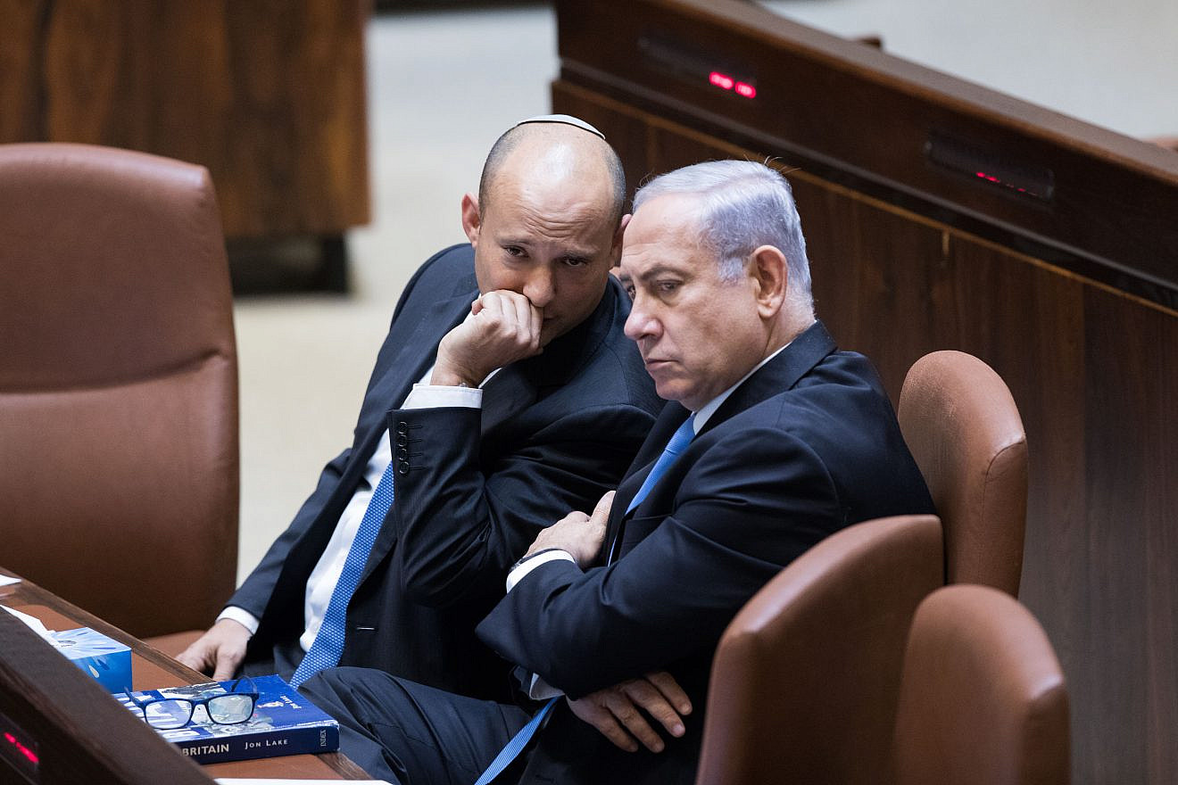 Israeli Prime Minister Benjamin Netanyahu speaks with then-Education Minister Naftali Bennett during a plenum session at the Knesset on Nov. 13, 2017. Photo by Yonatan Sindel/Flash90.
