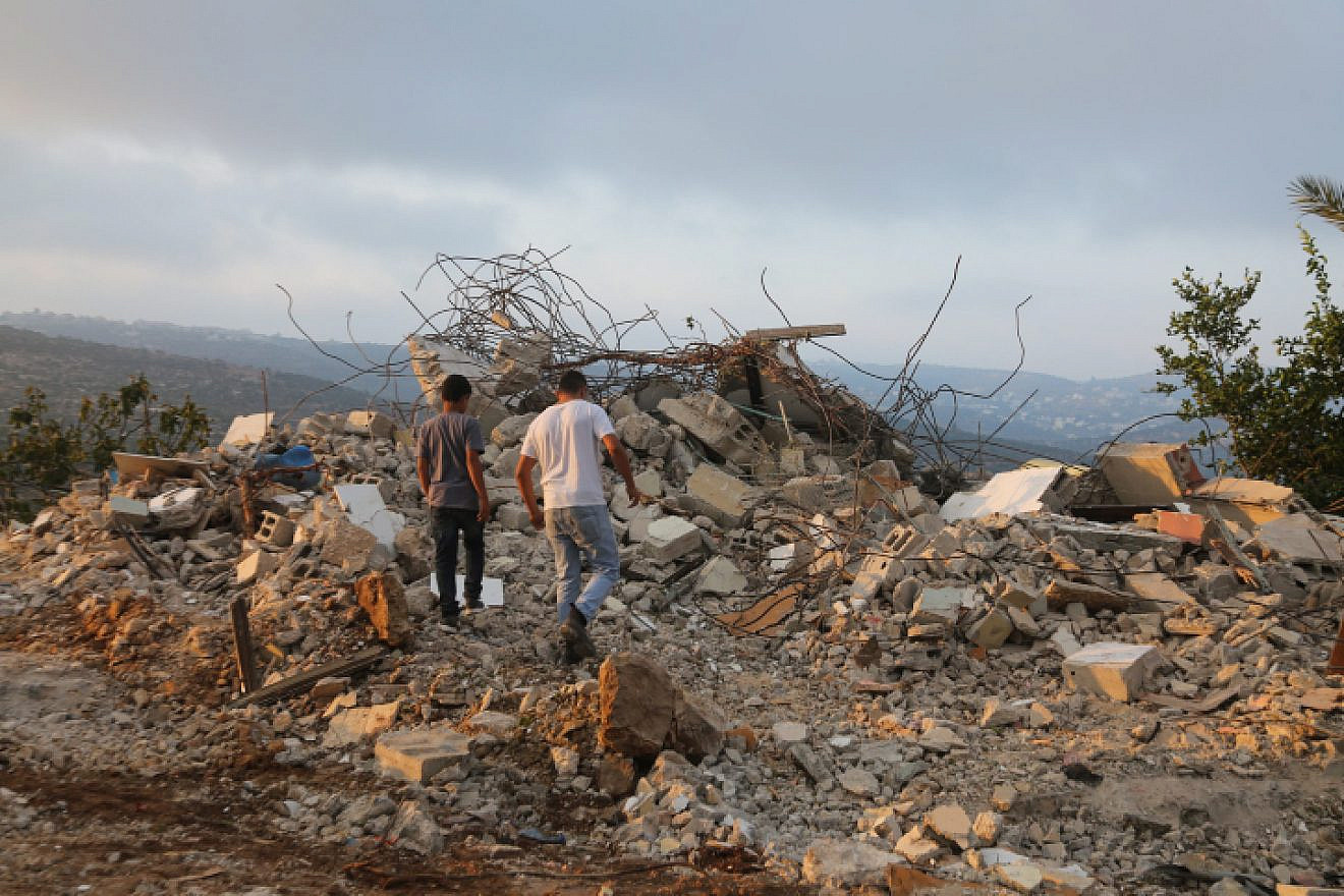 Palestinians inspect the home of terrorist Muhammad Dar Yusuf in Kobar, Samaria, which the IDF demolished on Aug. 28, 2018. Dar Yusuf murdered 31-year-old Yotam Ovadia in the town of Adam. Credit: Flash90.