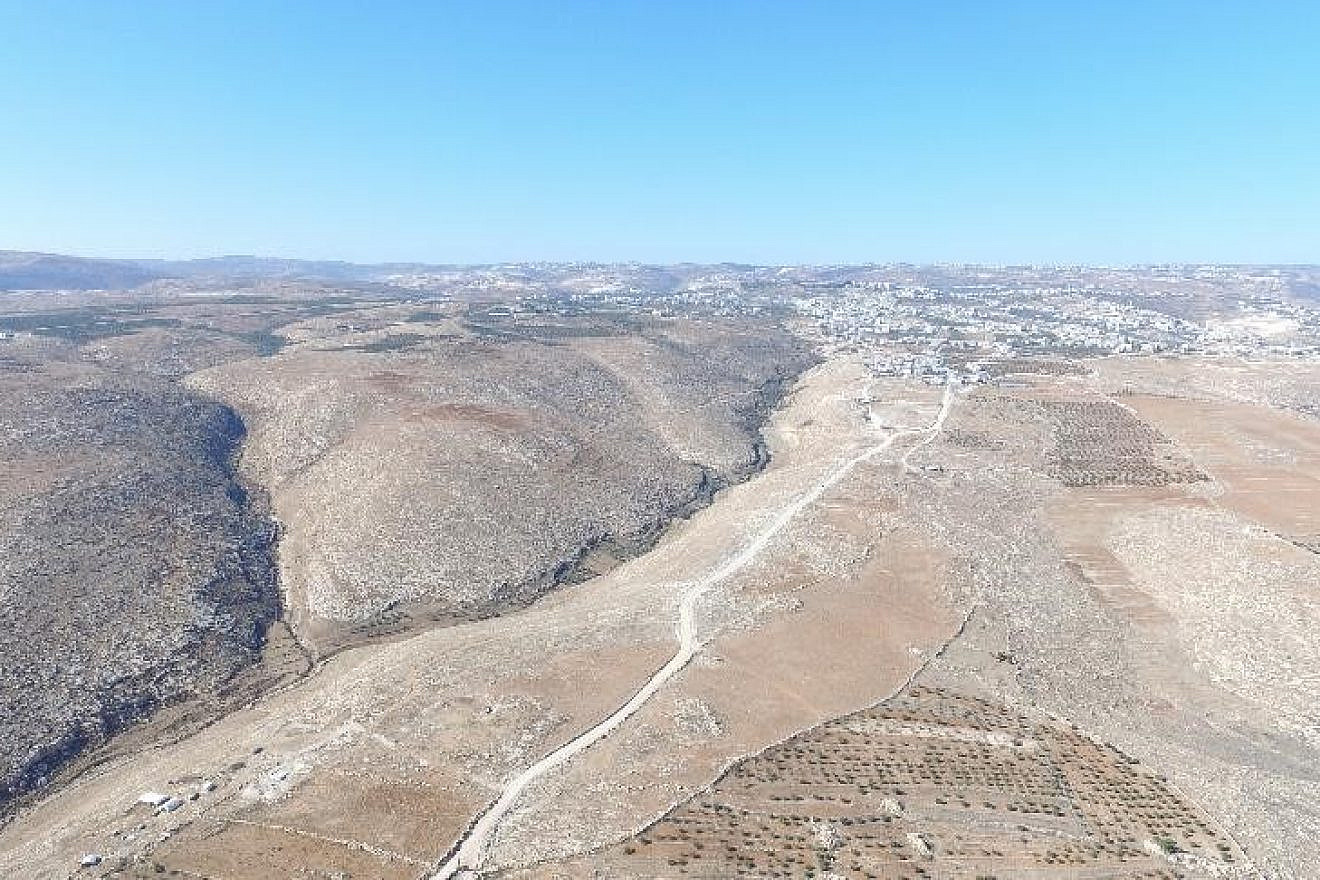 On Dec. 7, 2015, a representative of Regavim documented the completion of the preparations for paving. The images captured by drone photography clearly show that only a small section of the road passes through agricultural areas, while the vast majority of the road lies in arid, uninhabited areas, thus making it clear that the object of the Arab-oriented project is to seize territory in Area C and to annex the lands needed for a contiguous Palestinian state. Credit: Regavim.