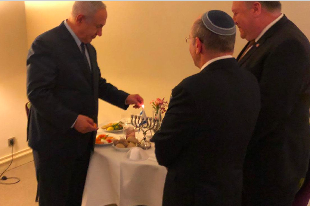 Israeli Prime Minister Benjamin Netanyahu, U.S. Secretary of State Mike Pompeo and National Security Council head Meir Ben-Shabbat light Hanukkah candles during a meeting in Brussels on Dec. 3, 2018. Credit: GPO.