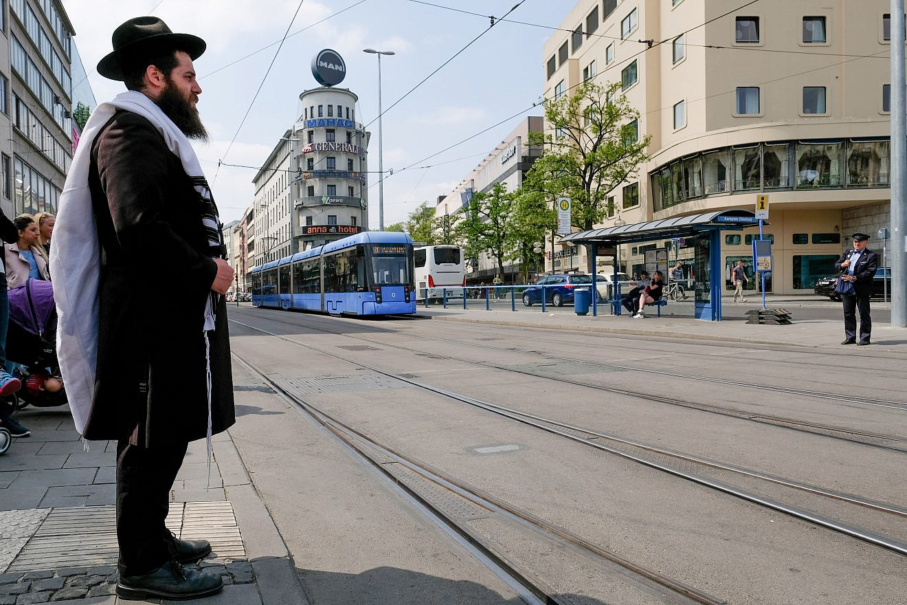 An observant Jewish man seen waiting on the streets in Munich, Germany. May 05, 2018. Credit: Nati Shohat/FLASH90