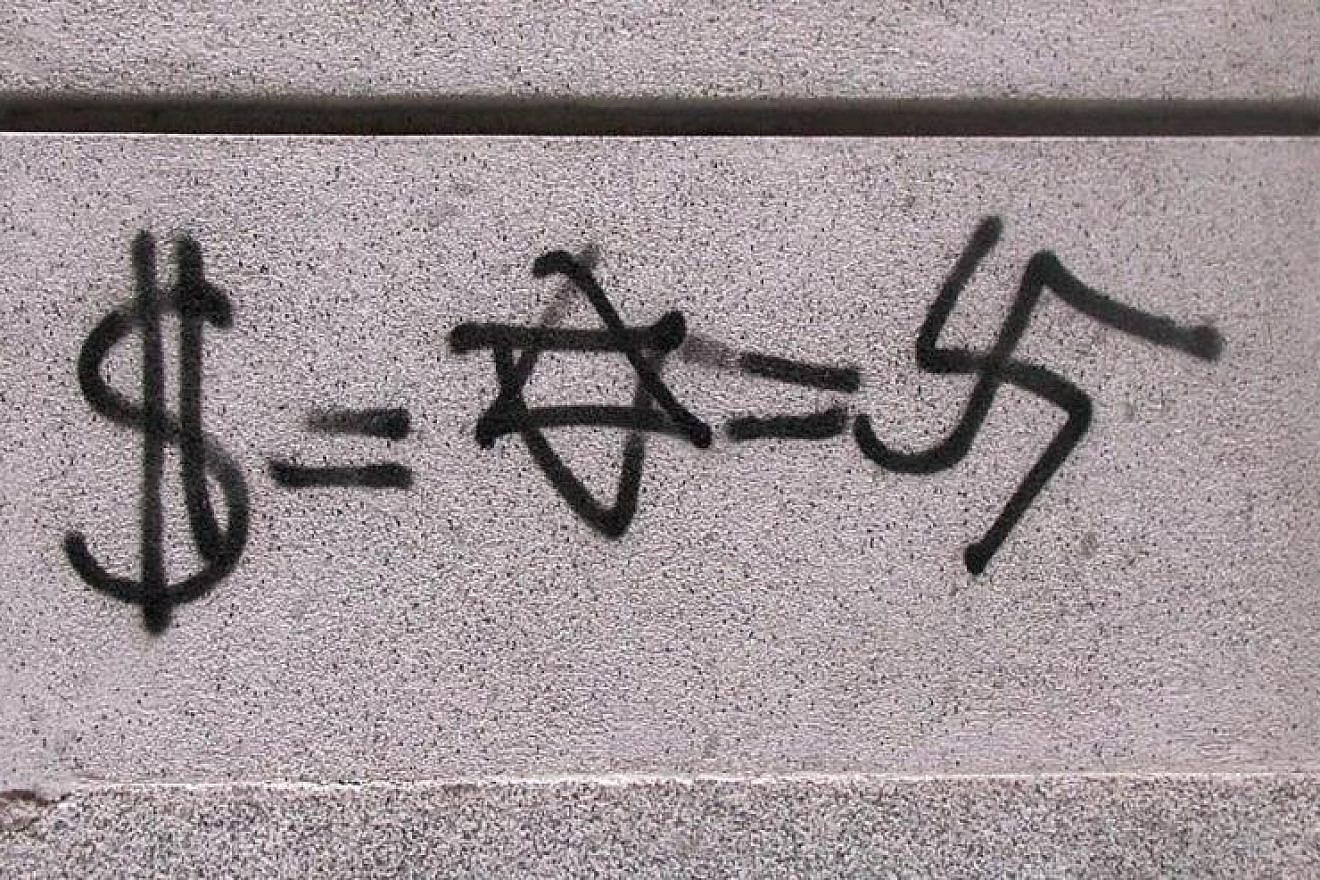 Anti-Semitic graffiti equating Judaism with Nazism and money, found in Madrid in 2003. Credit: Wikimedia Commons.