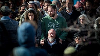 Friends and family members attend the funeral of Ori Ansbacher, 19, in the Jewish settlement of Tekoa on Feb. 8, 2019. The young woman was found dead the day before in Ein Yael, in the outskirts of Jerusalem, in what police declared a rape and murder. Photo Yonatan Sindel/Flash90.