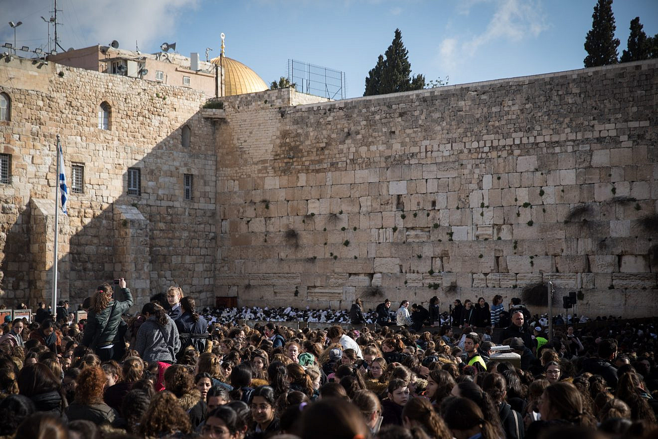 Members of the Women of the Wall movement hold Rosh Chodesh prayers as thousands of ultra-Orthodox women protest against them at the Western Wall in Jerusalem's Old City on March 8, 2019. Credit: Hadas Parush/Flash90.