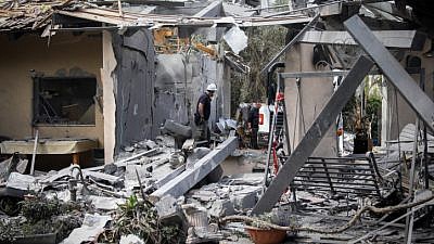 Israeli security forces inspect a house in Moshav Mishmeret, in central Israel, hit by a rocket fired from the Gaza Strip on March 25, 2019. Photo by Noam Revkin Fenton/Flash90.