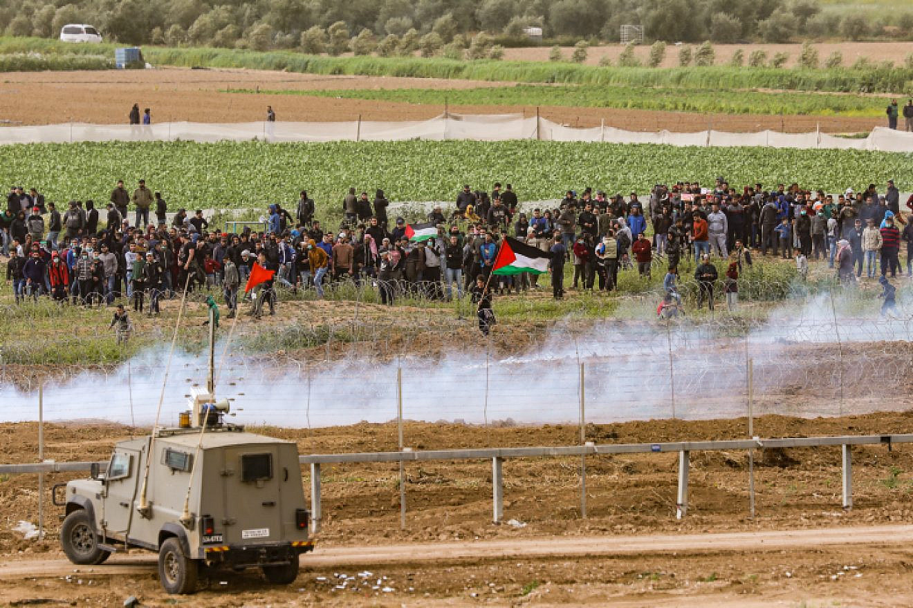 Israeli security forces clash with masses of Palestinian protesters, as seen from the Israeli side of the border with Gaza on March 30, 2019. Credit: Noam Revkin Fenton/Flash90.