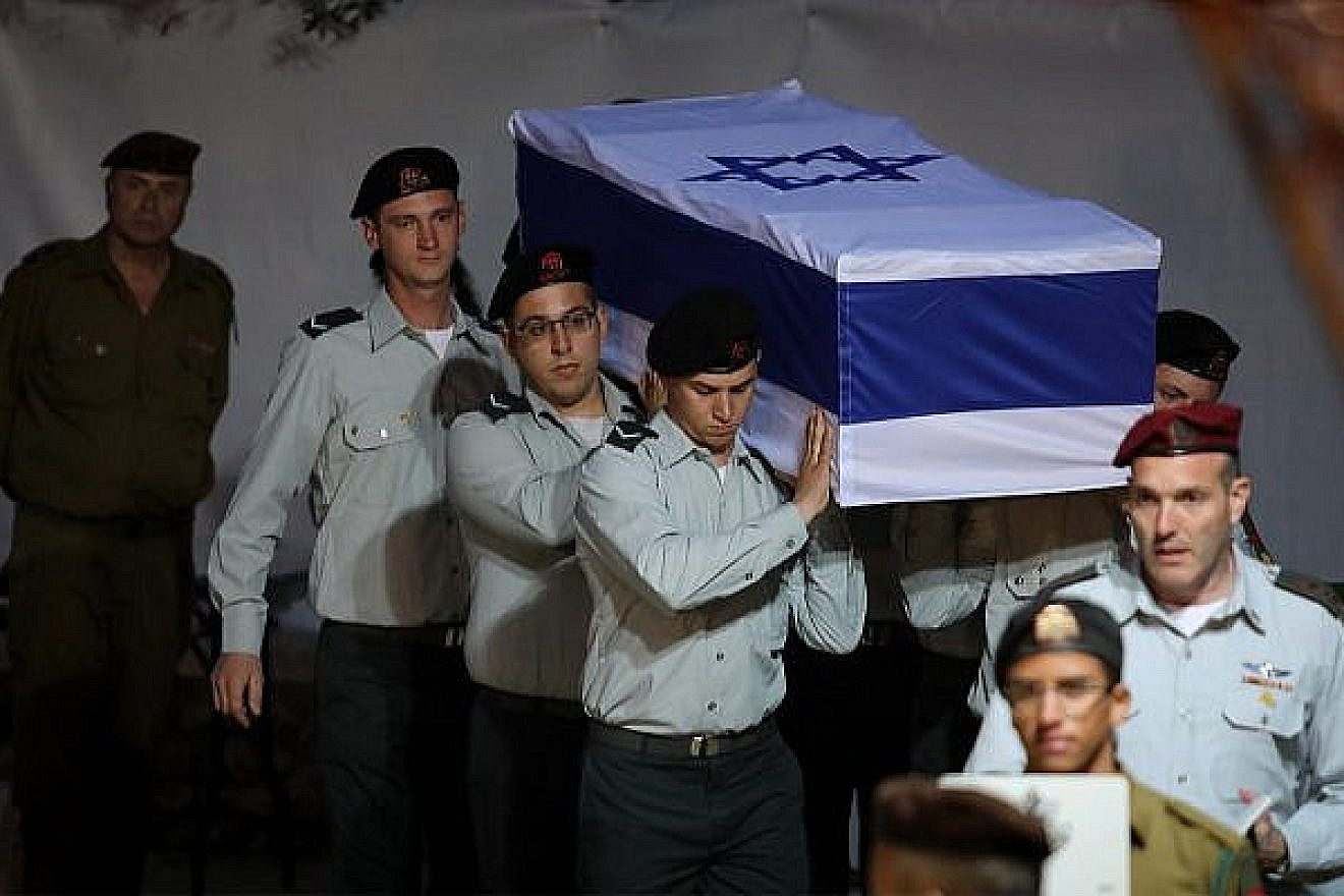 Israeli soldiers carry the coffin containing the remains of IDF soldier Sgt. First Class Zachary Baumel at the Mount Herzl Military cemetery in Jerusalem on April 4, 2019. Credit: Hadas Parush/Flash90.
