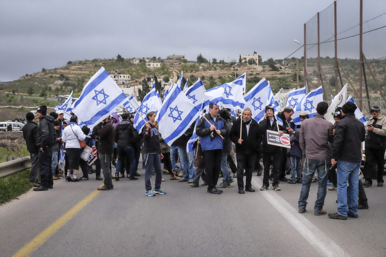 Hundreds march with Israeli flags and signs reading "bringing back deterrence" from the Jewish settlement of Karmei Tzur to the Gush Etzion Junction in the settlement bloc in the West Bank, on March 15, 2016. Photo by Gershon Elinson/Flash90.