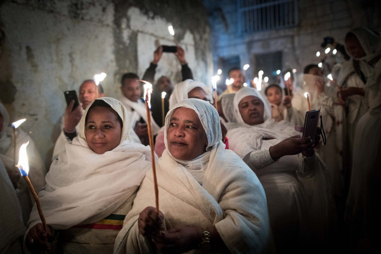 Ethiopian Orthodox Christian worshippers hold candles outside Deir Al-Sultan in the Church of the Holy Sepulcher during the ceremony of the Holy Fire in Jerusalem's Old City, Saturday, April 27, 2019. Photo by Noam Revkin Fenton/Flash90.