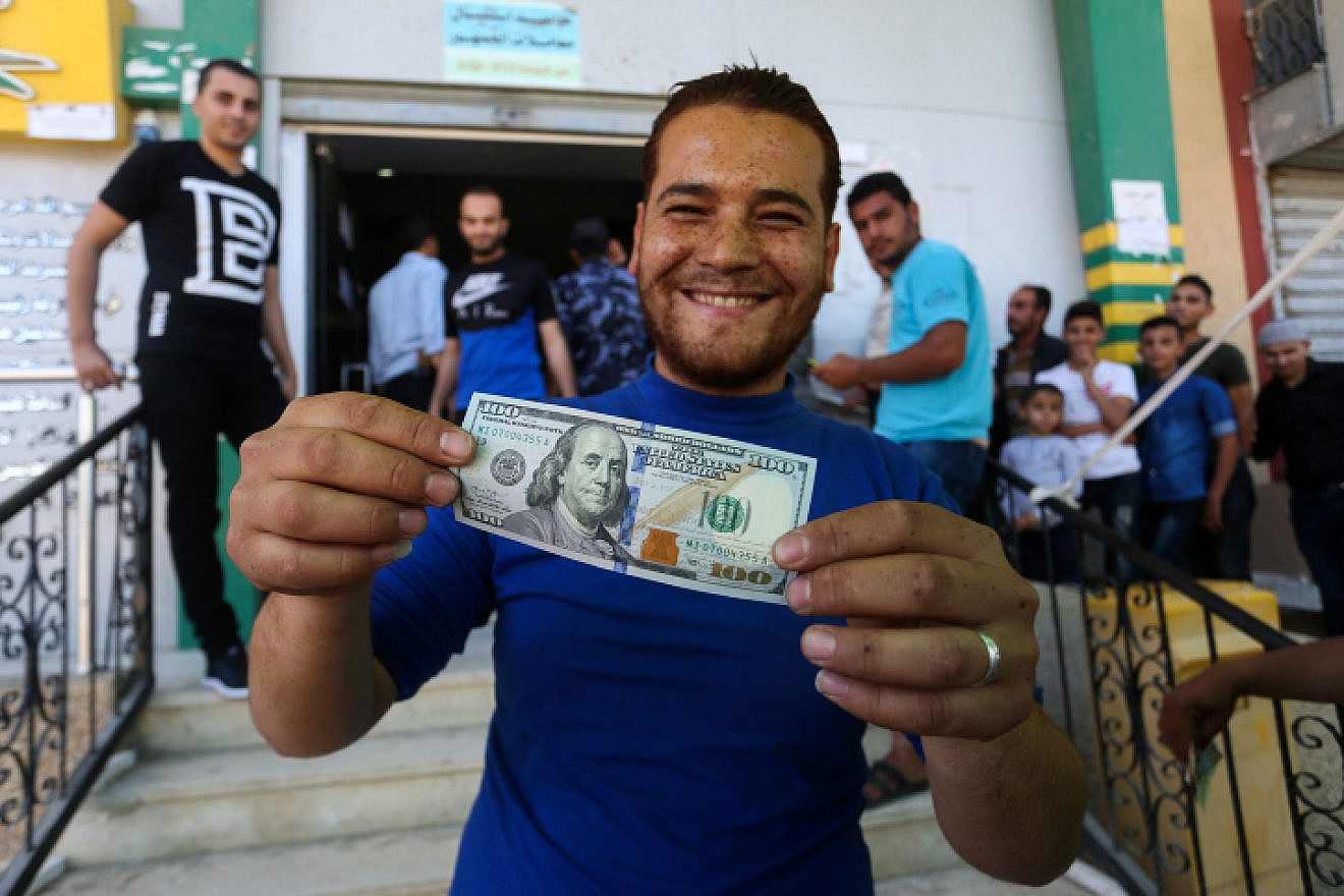 Palestinians receive cash as part of $480 million in aid allocated by Qatar, at a post office in Gaza City on May 19, 2019. Photo by Abed Rahim Khatib/Flash90.