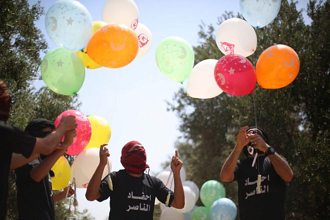 Palestinian youths in the Gaza Strip prepare incendiary balloons with which to attack Israel, May 31, 2019. Photo by Hassan Jedi/Flash90.