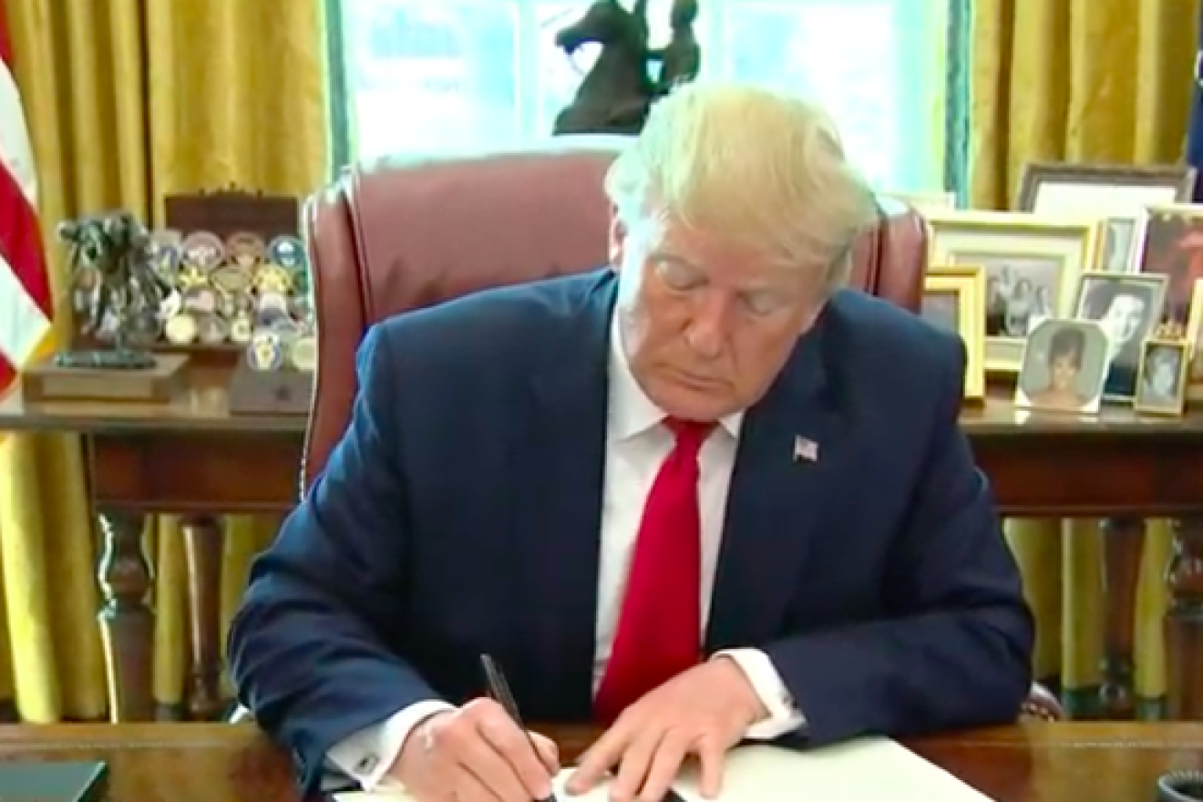 U.S. President Donald Trump signs an executive order regarding Tehran and Iranian Supreme Leader Ayatollah Ali Khamenei on June 24, 2019. Source: Screenshot.