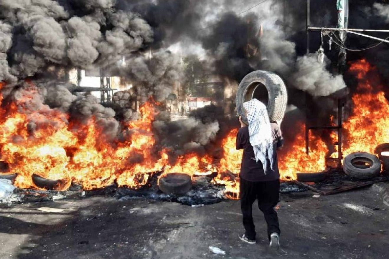 A fire rages during a demonstration in a Palestinian refugee camp in Lebanon on July 16, 2019. Source: Lebanese press.