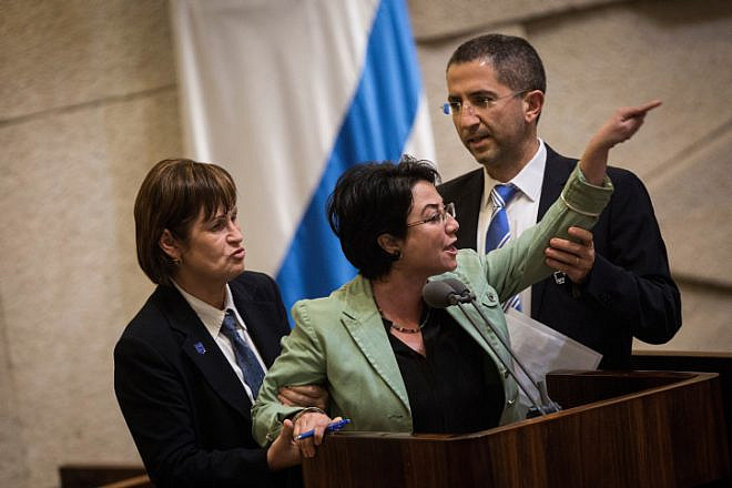 Knesset member Hanin Zoabi is removed by Knesset security during her speech at a plenum session before a vote on a bill requiring left-wing foundations and organizations to reveal their sources of funding, on Feb. 8, 2016. Photo by Hadas Parush/Flash90.
