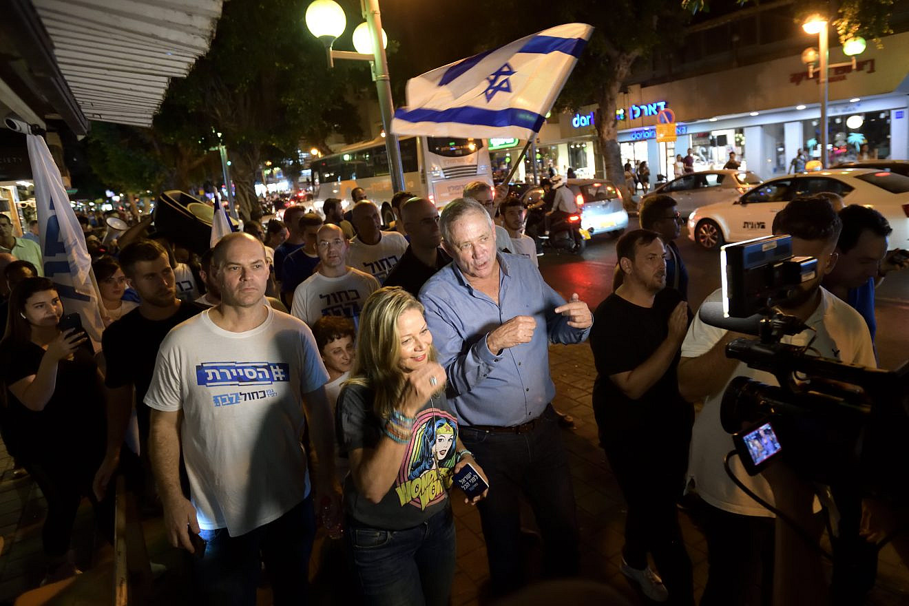 Benny Gantz (center), head of Blue and White Party, mingles with young supporters at a bar on Dizengoff Street in Tel Aviv as part of his election campaign efforts, Aug. 22, 2019. Photo by Gili Yaari/Flash90.