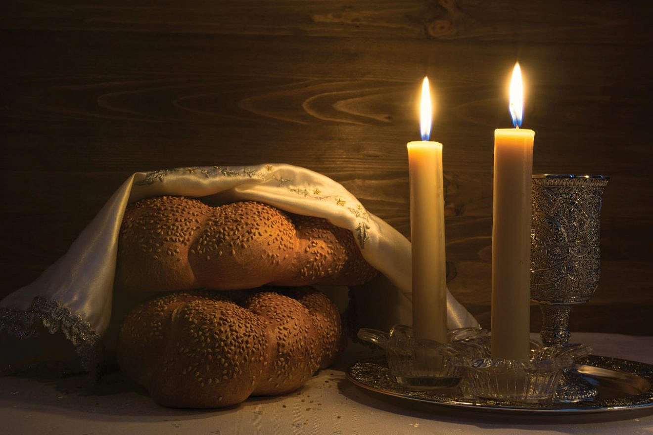 Challah and candles lit prior to the start of Shabbat.