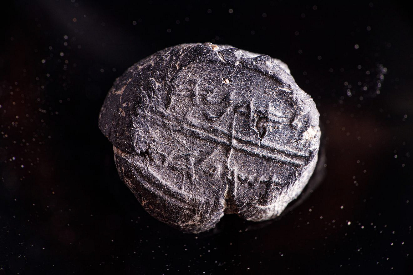 This bulla, or seal, dating to the seventh century B.C.E., was found during an archaeological dig in Jerusalem's Old City. The seal bears the inscription “Adoniyahu Asher Al Habayit.” meaning "Adoniyahu, Royal Steward." Credit: Eliyahu Yanai, City of David.