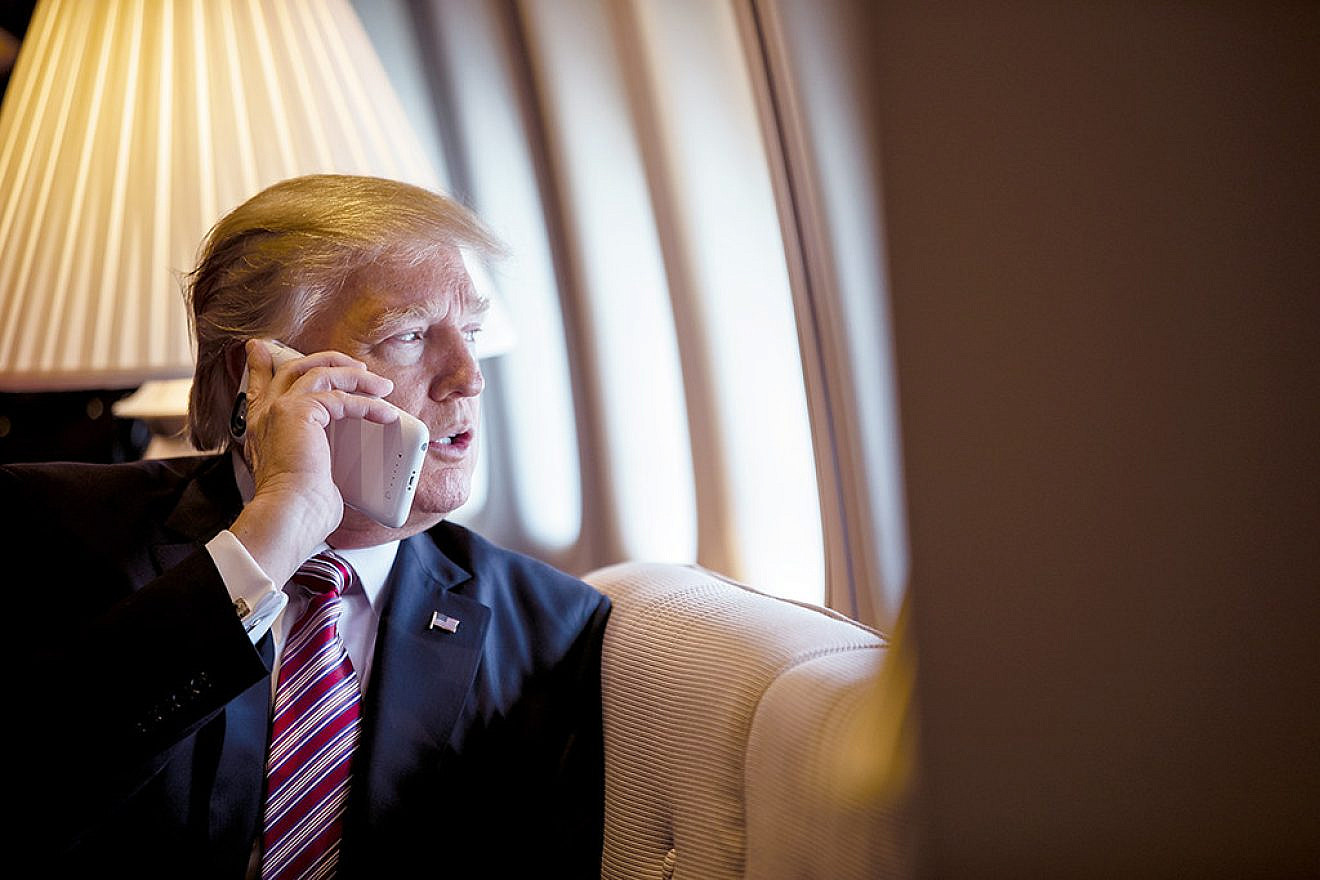 U.S. President Donald Trump talks on the phone aboard Air Force One during a flight to Philadelphia to address a joint gathering of House and Senate Republicans on Jan. 26, 2017. This was the president's first trip aboard Air Force One. Credit: Shealah Craighead/White House Photo.