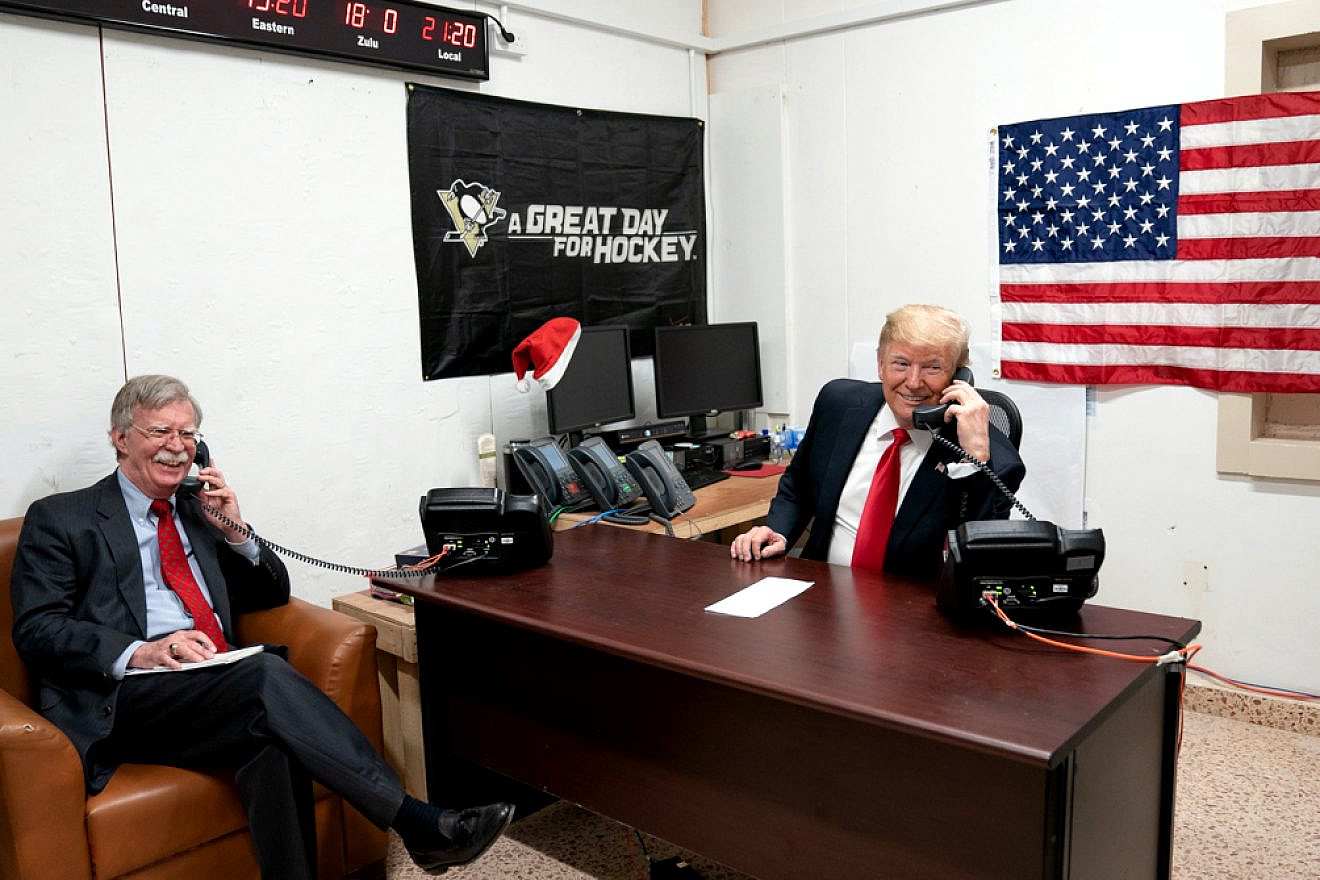 U.S. President Donald Trump, joined by National Security Advisor John Bolton, speaks on the phone with Iraqi Prime Minister Adil Abdul-Mahdi during a visit to the Al-Asad Airbase in Iraq on Dec. 26, 2018. Credit: Official White House Photo by Shealah Craighead.