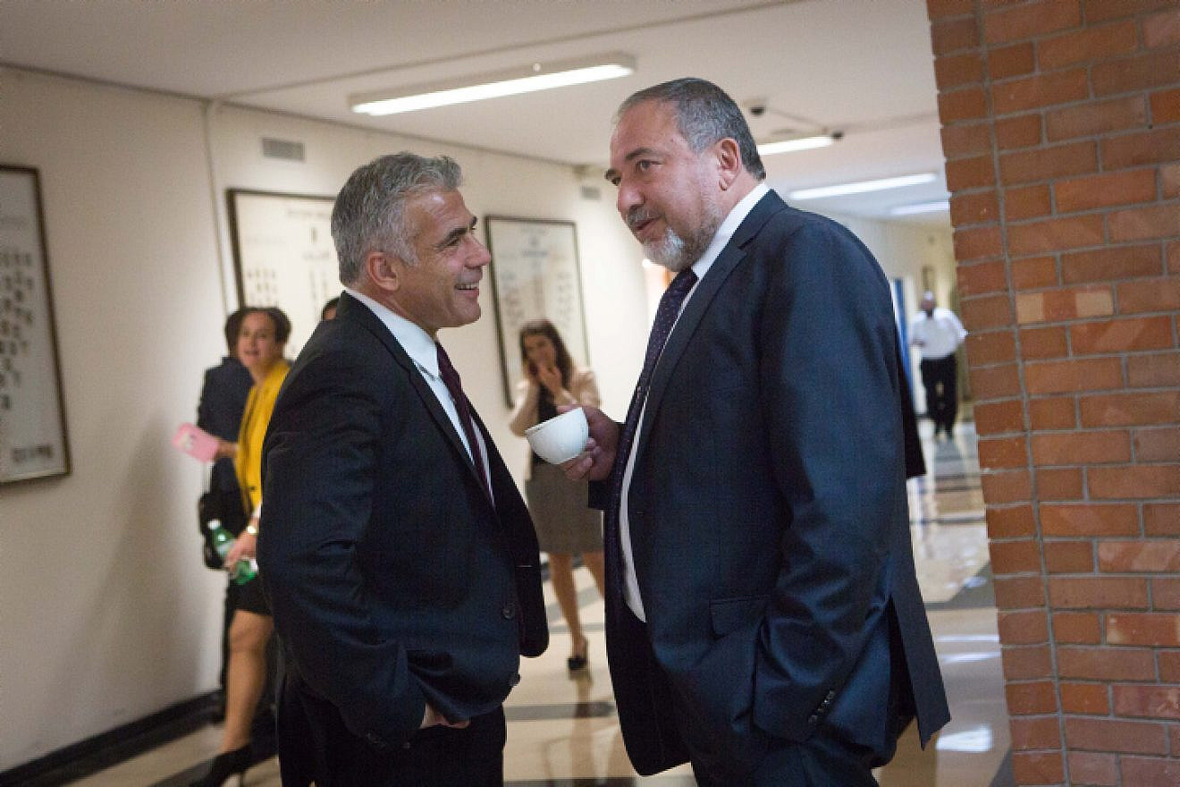 Yisrael Beiteinu leader Avigdor Lieberman (right) speaks with Yesh Atid Party leader Yair Lapid in the corridors of the Knesset on Nov. 16, 2015. Photo by Miriam Alsterl/Flash90.