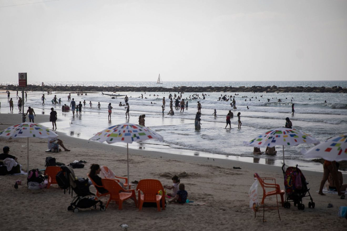 Israelis enjoy the beach on a hot day in Tel Aviv, on Aug. 29, 2019. Photo by Hadas Parush/Flash90.