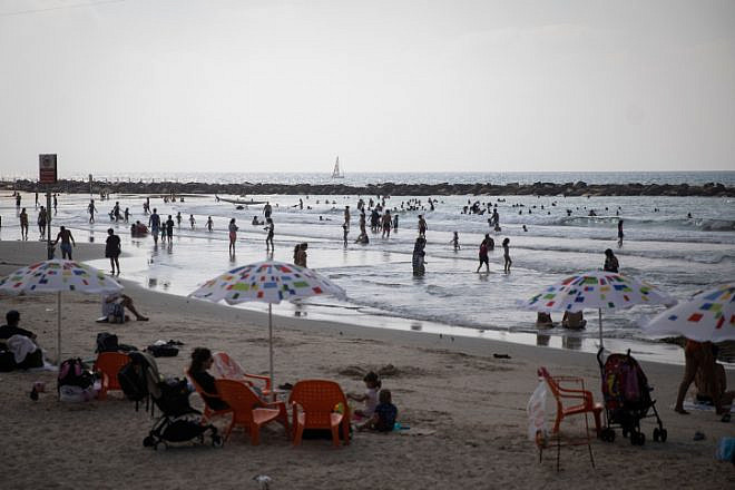 Israelis enjoy the beach on a hot day in Tel Aviv, on Aug. 29, 2019. Photo by Hadas Parush/Flash90.